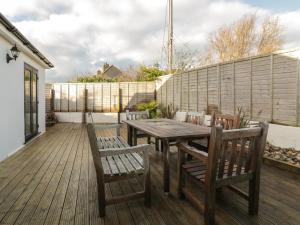 a wooden table and chairs on a wooden deck at Crantock Lodge in Newquay
