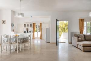 a kitchen and living room with a table and a couch at Villa Dina Chalikounas Corfu in Halikounas