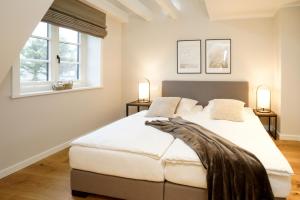 Un pat sau paturi într-o cameră la Ferienhaus Inselwind Sylt