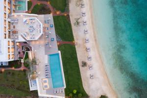 an aerial view of a resort with a pool and the beach at Vathi Cove Luxury Resort & Spa in Chrysi Ammoudia