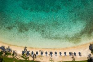 an overhead view of a beach with a group of chairs at Vathi Cove Luxury Resort & Spa in Chrysi Ammoudia
