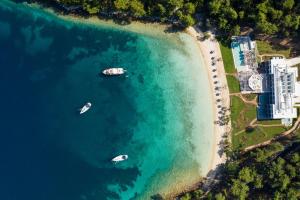 an aerial view of a beach with boats in the water at Vathi Cove Luxury Resort & Spa in Chrysi Ammoudia