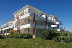 a large apartment building with balconies on a lawn at Studio - 700m plage port - 200m golf - wifi - piscine in Pornic