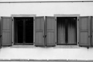 three windows on the side of a building at Casa Pesarina in Prato Carnico