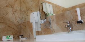 a bathroom with a phone on the wall next to a sink at Agropolog Hotel & Spa in Želino