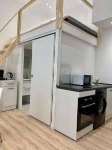 a kitchen with a washer and dryer in a room at Gustave 2 in Nice +7 photos