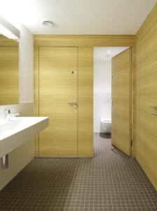 a bathroom with a toilet and a sink and a shower at Scuol Youth Hostel in Scuol