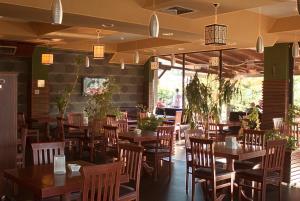 a dining room with wooden tables and chairs at Agropolog Hotel & Spa in Želino