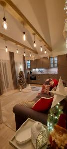 a living room with a christmas tree and a couch at Brīvdienu māja ar Saunu in Saulkrasti