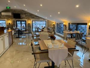 a restaurant with tables and chairs and a brick wall at Mr Beyaz Hotel Sisli Istanbul in Istanbul