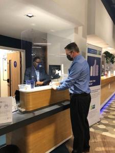 a man standing in front of a counter in a restaurant at Holiday Inn Express - Birmingham - City Centre, an IHG Hotel in Birmingham