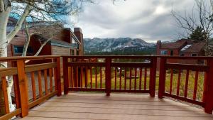 a wooden deck with a view of the mountains at Meadow Ridge #28 condo in Mammoth Lakes +22 photos