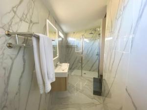 a bathroom with a shower and a sink and a mirror at Hôtel La Villa d'Eze in Éze +27 photos