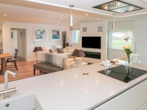 a kitchen and living room with a couch and a table at 2 Sails in Dartmouth