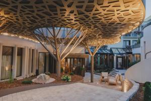 a wooden canopy over a courtyard in a building at Kunzmann's Hotel | Spa in Bad Bocklet