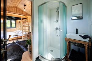 a bathroom with a shower and a sink at Joly Tiny House in Overijse