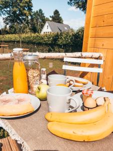 a table with bananas and other foods on it at Joly Tiny House in Overijse