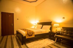 A bed or beds in a room at AVISHA TOWN HOTEL