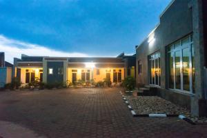 a building with a brick driveway in front of it at AVISHA TOWN HOTEL in Kigali