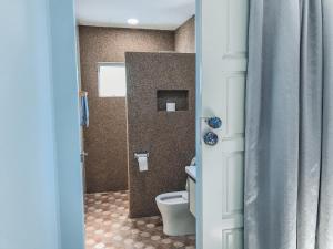 a bathroom with a toilet and a shower at Guesthouse Dragon Place in Taiping