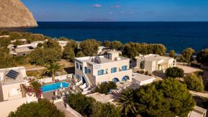 an aerial view of a villa with the ocean in the background at Stelios Place in Perissa