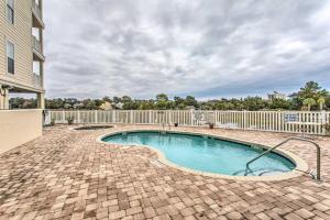 a swimming pool in a yard with a fence at North Myrtle Beach Condo with Views Walk to Beach! in Myrtle Beach