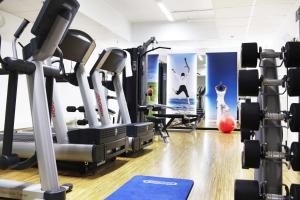 a gym with treadmills and cardio equipment at Scandic Aarhus City in Aarhus