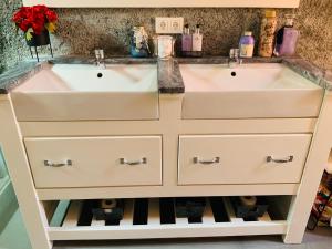 two white sinks in a bathroom with a counter at Techas City Center Luxurious Suite in Praia