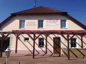 a building with a sign on the side of it at Penzion Oliver in Horní Planá