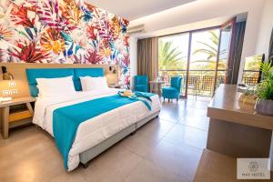 a hotel room with a bed and a balcony at May Beach Hotel in Rethymno Town