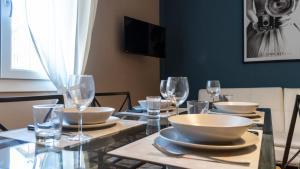 a dining room table with bowls and glasses on it at Italianway - Riva di Reno 47 B in Bologna