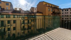 a fence on top of a building with buildings at Italianway - Riva di Reno 47 B in Bologna