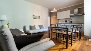 a kitchen and a living room with a table and a couch at Italianway - Riva di Reno 47 B in Bologna