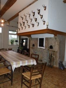 a dining room with a table and a stone fireplace at Landhaus Holthausen in Werne an der Lippe