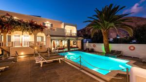 a house with a swimming pool at night at Stelios Place in Perissa