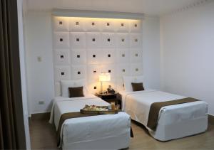 Postel nebo postele na pokoji v ubytování Inkari Suites Hotel