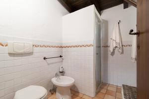 a bathroom with a toilet and a sink at Il Trullo - Tia Maria Country Inn in Racale +29 photos