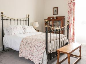 a bedroom with a bed and a wooden table at St Agnes in Duns