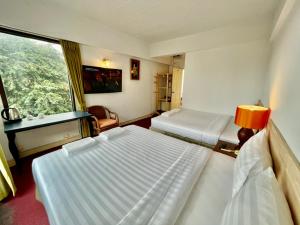 Postel nebo postele na pokoji v ubytování MANGO Lagoon Place