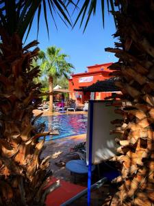 a pool with a painting next to a resort at Le Relais De Marrakech in Marrakech