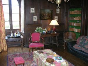 a living room with a couch and a table at Château des Lutz in Daon