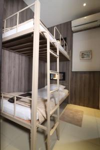 A bed or beds in a room at The Cabin Tanjung Yogyakarta
