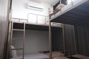 A bed or beds in a room at The Cabin Tanjung Yogyakarta