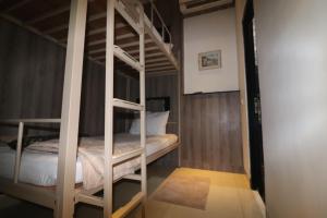 A bed or beds in a room at The Cabin Tanjung Yogyakarta