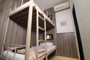 A bed or beds in a room at The Cabin Tanjung Yogyakarta