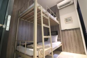 A bed or beds in a room at The Cabin Tanjung Yogyakarta