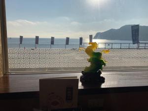 a toy figurine sitting on a table in front of a window at Kamogawa Shokudo - Vacation STAY 15119v in Kamogawa