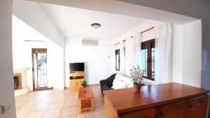 a living room with a couch and a table at Villa Costa in Moraira
