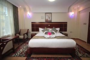 a hotel room with a bed with a basket on it at Vickmark Hotel in Nakuru