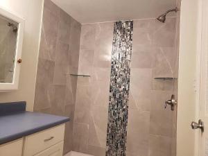 a shower in a bathroom with a shower curtain at Enjoy the sunset at OCEAN FRONT 1BR Apartment - pool on site! in Kailua-Kona